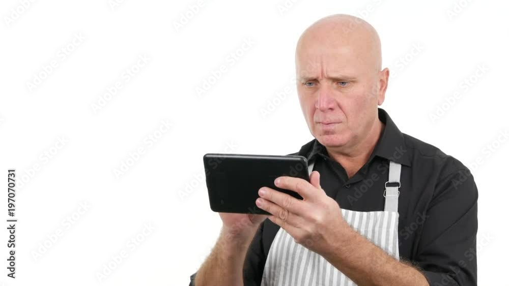 Angry and Disappointed Man Wearing Apron Use Laptop Angry and Disappointed Man Wearing Apron Use Laptop