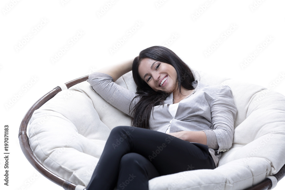 Obraz premium young woman sitting in a comfortable soft big armchair