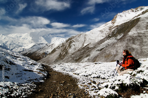 Trek in Nepal. Annapurna cirkut trek. Traveller while climbing to the pass Thorong-la