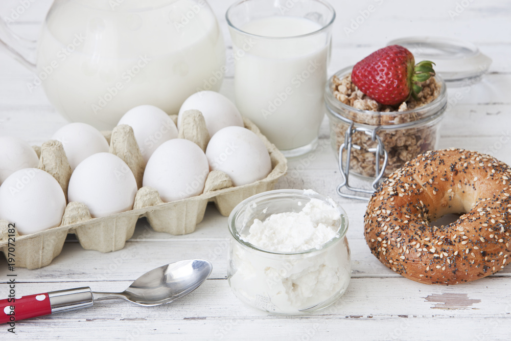 Ricotta, granola, fresh bread and egg - homemade healthy breakfast. Close-up, selective focus, shallow depth of field, white wood background Ricotta, granola, fresh bread and egg - homemade healthy breakfast. Close-up, selective focus, shallow depth of field, white wood background