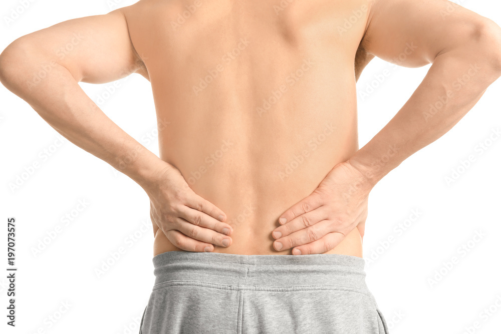 Fototapeta premium Young man suffering from back pain on white background