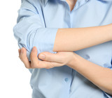 Young woman suffering from elbow pain on white background