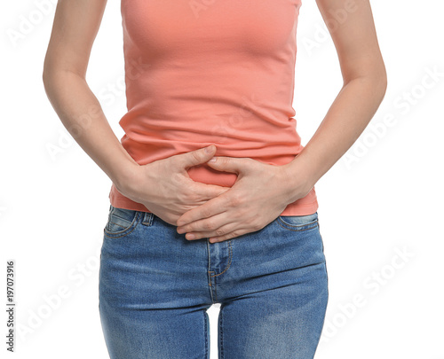 Young woman suffering from abdominal pain on white background © New Africa