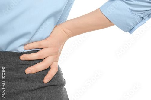 Young woman suffering from back pain on white background © New Africa