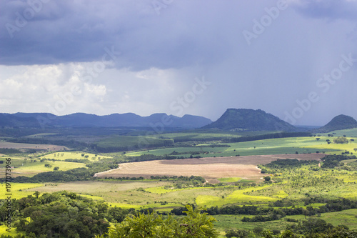 Beautiful mountainous landscape in the interior of Brazil. Some farms  a small town and some plantations are visible