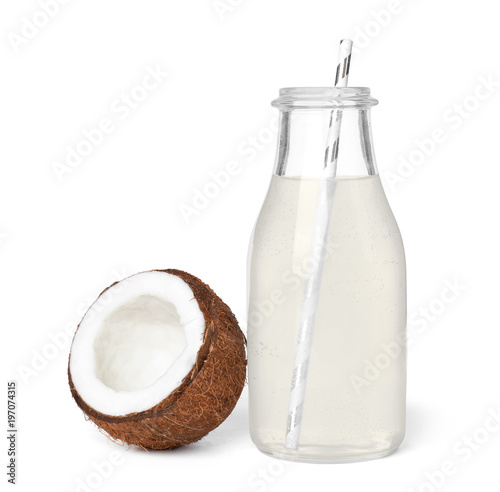 Bottle of coconut water and fresh nut on white background