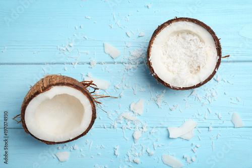 Composition with fresh coconut flakes on color wooden background, top view