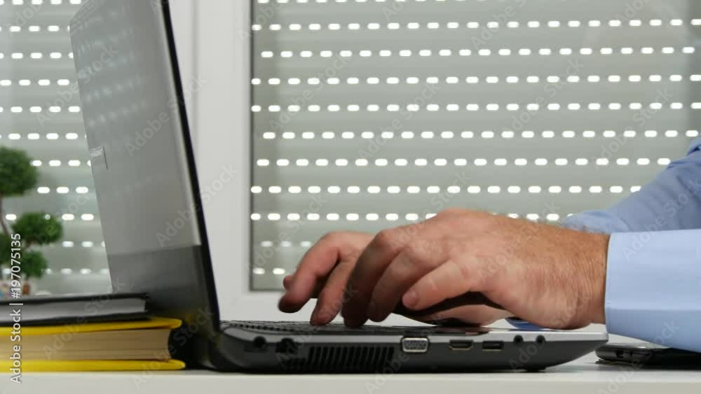 Man in Office Room Working Using a Laptop Man in Office Room Working Using a Laptop