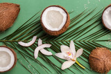 Composition with coconut water and fresh nuts on color background