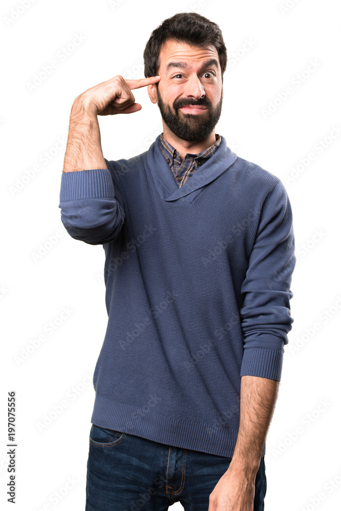 Handsome brunette man with beard making crazy gesture on white background Handsome brunette man with beard making crazy gesture on white background