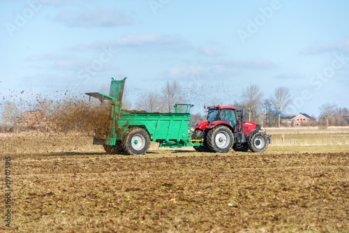 Tractor with manure spreader on the field - 1358