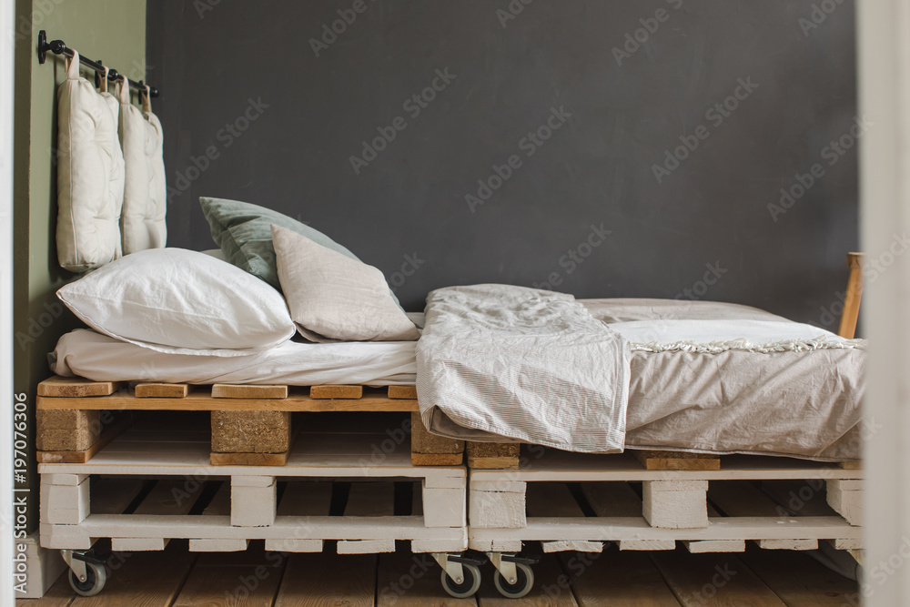 A industrial style bedroom with recycled pallet bed frame designs Stock  Photo | Adobe Stock