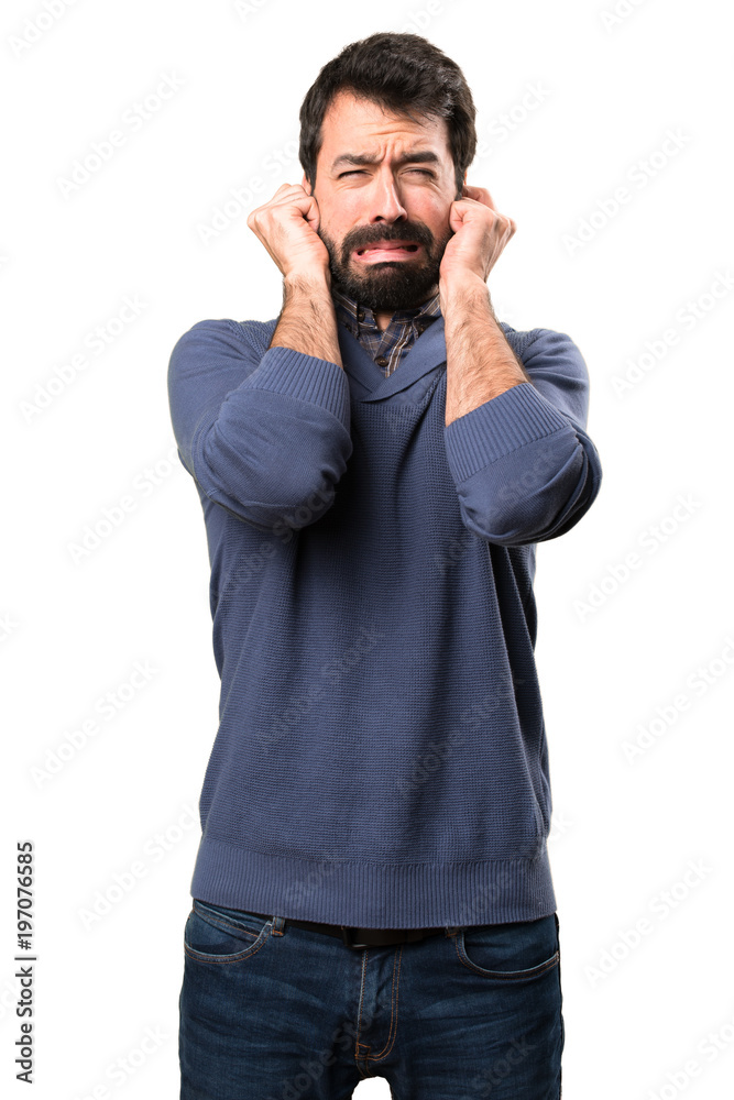 Handsome brunette man with beard covering his ears on white background Handsome brunette man with beard covering his ears on white background
