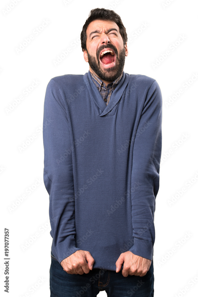 Handsome brunette man with beard shouting on white background