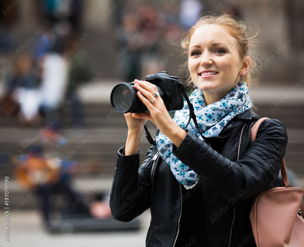 Young female traveller with camera