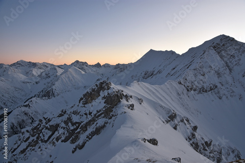 View from the summit of Tauberspitze (Lechtal Alps) after sunset at a cold winter day. Tirol, Austria