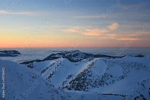 Colorful sunset at the summit of Ponten in winter. Allgaeu Alps, Bavaria, Germany