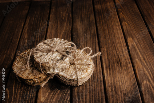 Top View of Crafted Cheese on Wooden Background with Free Space for Text at the Right Side of the Photo.