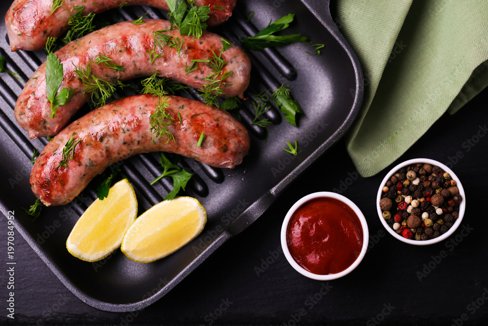 Grilled sausages with lime on iron grill pan Grilled sausages with lime on iron grill pan