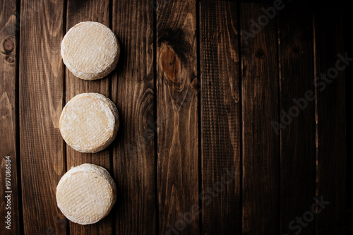 Top View of Crafted Camembert on Wooden Background with Free Space for Text at the Right Side of the Photo.