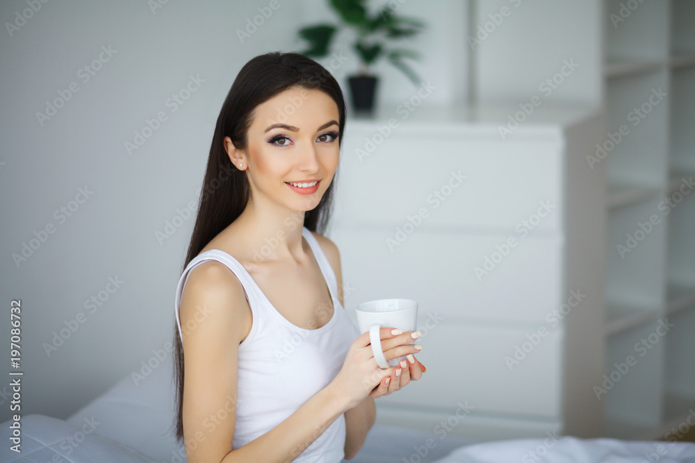 Young Beautiful Woman Sitting on Bed Young Beautiful Woman Sitting on Bed