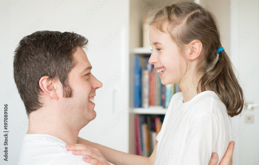 Happy father and daughter in front of each other. Happy father and daughter in front of each other.