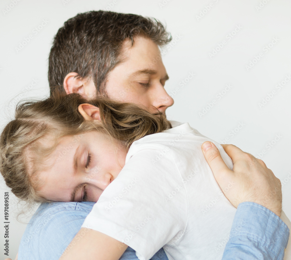 Sad little girl hugging her dad. Sad little girl hugging her dad.