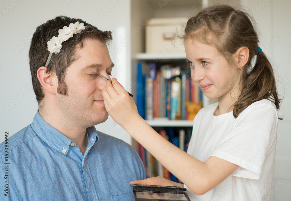 Cute little girl making makeup to her dad. Cute little girl making makeup to her dad.