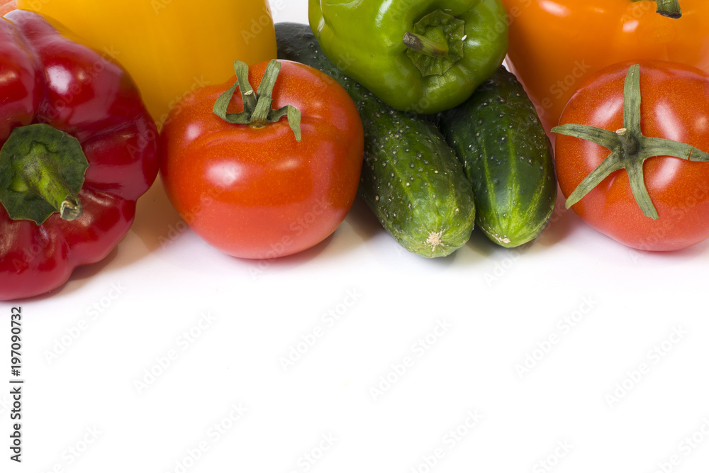 Red yellow and orange peppers with tomatoes on a white background. Cucumbers with colorful peppers in composition on a white background. Red yellow and orange peppers with tomatoes on a white background. Cucumbers with colorful peppers in composition on a white background.
