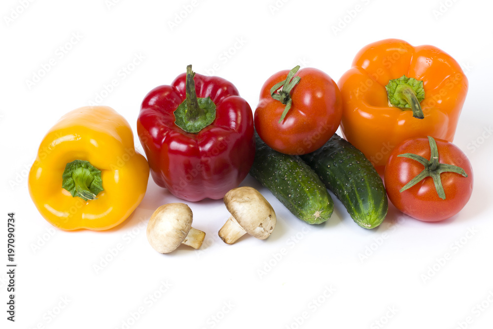 Red yellow and orange peppers with tomatoes on a white background. Red yellow and orange peppers with tomatoes on a white background.