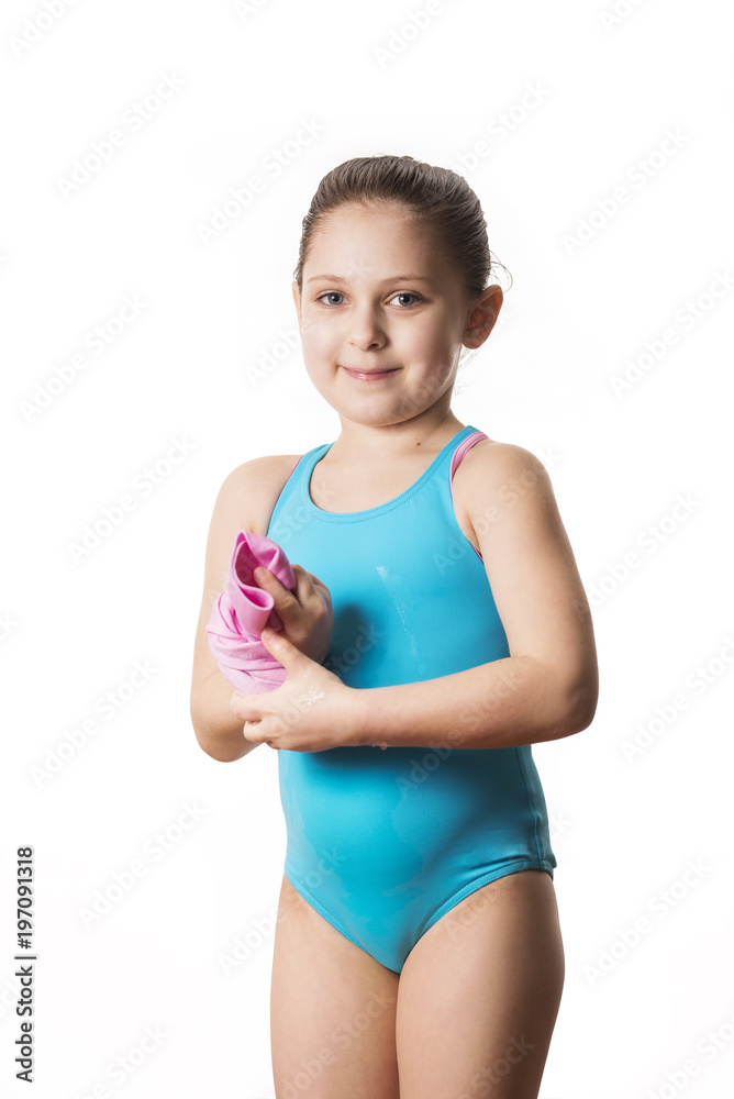 Little caucasian 7 years old cute caucasian girlie in cyan swimming costume holding a shammy Little caucasian 7 years old cute caucasian girlie in cyan swimming costume holding a shammy