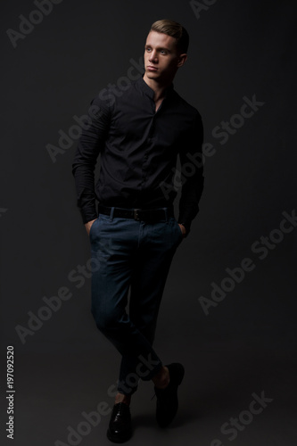 Portrait of handsome, man against dark background. © Skripnik Olga