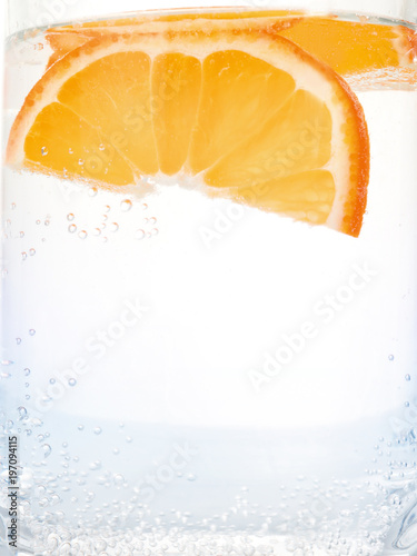Orange slices into clear water