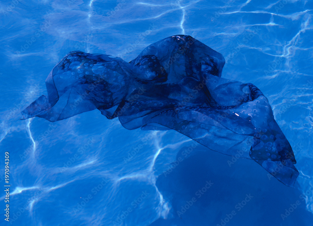 Blue fabric floating in pool Stock Photo