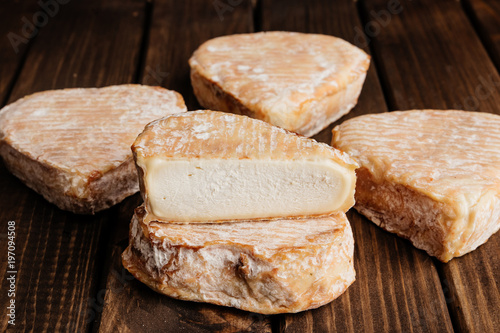 Top View of Delicious Cheese on Wooden Brown Background.