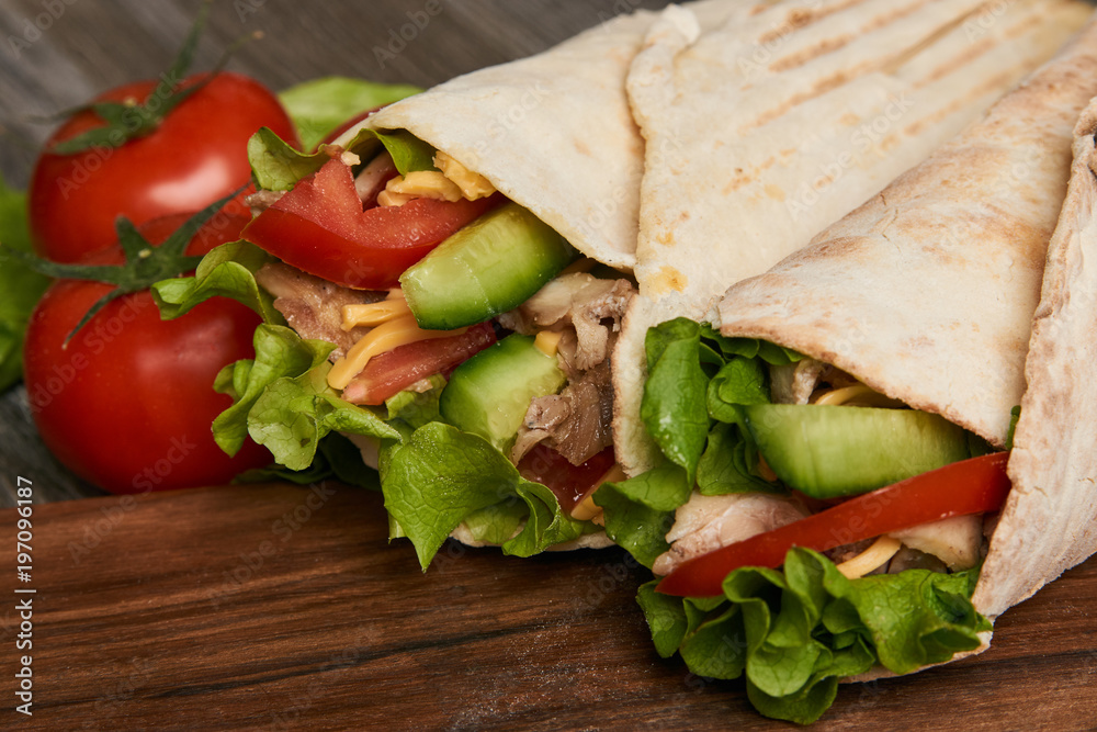 Obraz premium Shawarma Sandwich with fresh vegetables and chicken grilled meat, Doner Kebab, Chicken Shawarma, Burrito