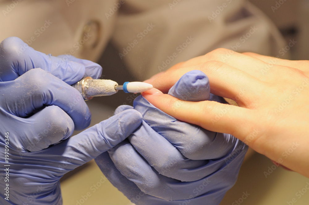 Professional manicure process in beauty salon.