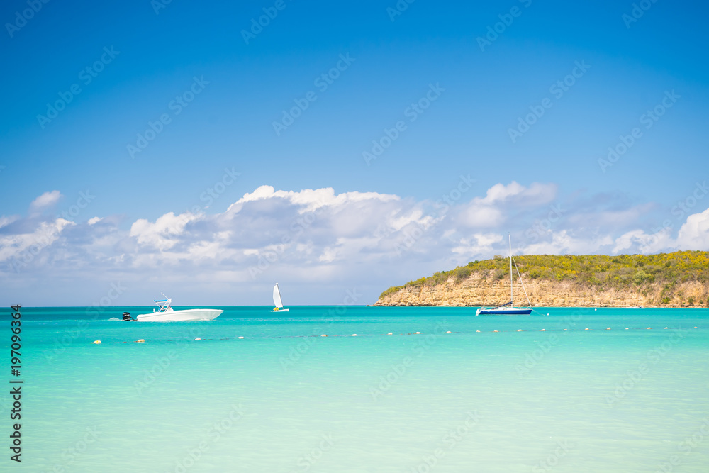 Boats on calm sea water in Antigua on sunny day. Water transport, sport, activity. Summer vacation on caribbean. Wanderlust, travel, trip. Adventure, discovery, journey