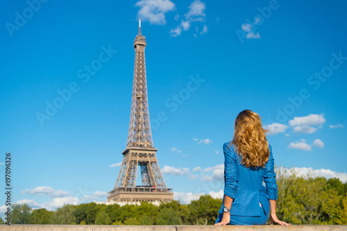 Woman in blue dress look at eiffel tower in paris, france, fashion. Woman with long hair, hairstyle, rear view, beauty. Fashion, style, trend. Beauty, look, hair, hairstyle. Vacation, travel, journey © be free