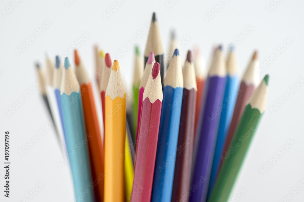 Close up of wooden colorful pencils, group of scattered crayons, isolated od white background Close up of wooden colorful pencils, group of scattered crayons, isolated od white background