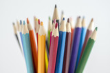 Close up of wooden colorful pencils, group of scattered crayons, isolated od white background