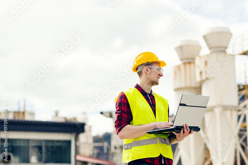 Industrial worker using laptop