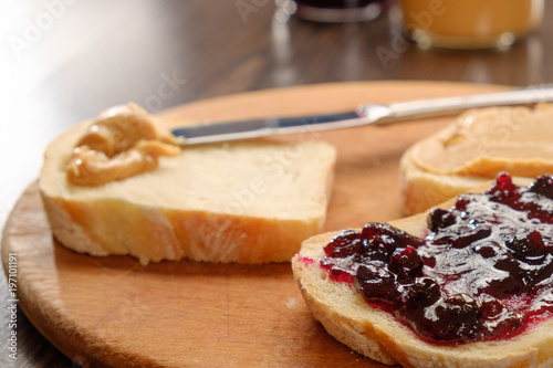 peanut butter sandwich with jam on cutting board