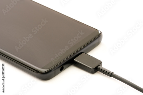Smartphone charging. Isolated on white background.