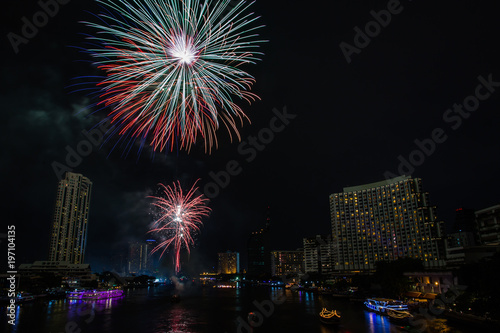 Night view of Taksin bridge in Bangkok with firework