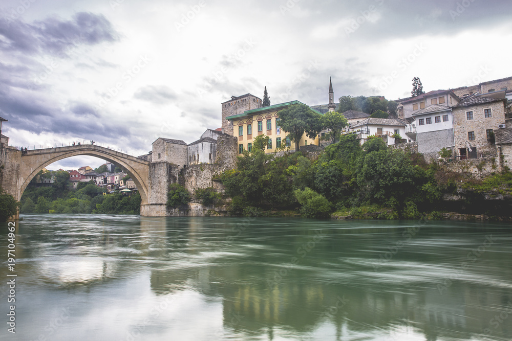 View of the single-arch Old Bridge or Stari Most Neretva over River in Mostar, Bosnia and Herzegovina. The Old Bridge was destroyed in 1993 by Croat military forces during the Croat–Bosniak War. View of the single-arch Old Bridge or Stari Most Neretva over River in Mostar, Bosnia and Herzegovina. The Old Bridge was destroyed in 1993 by Croat military forces during the Croat–Bosniak War.
