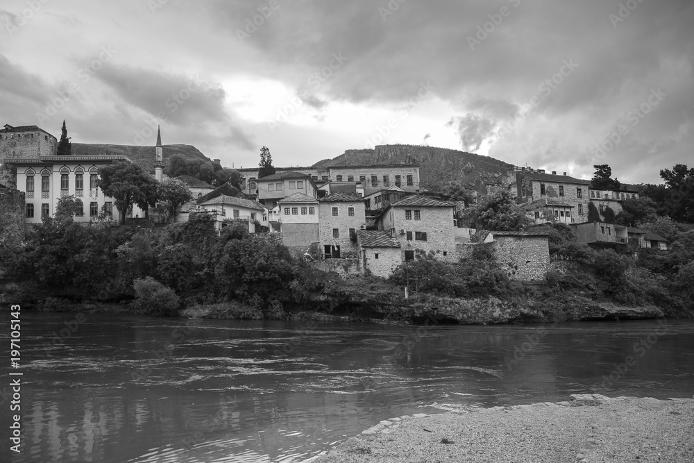 Black and white view of Old Town Mostar from the bank of Neretva River, Bosnia and Herzegovina.