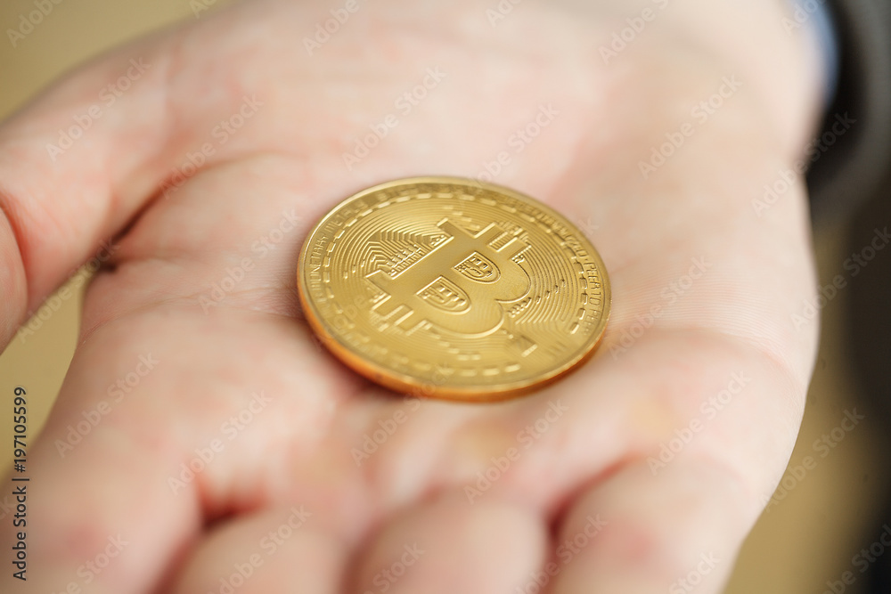 Businessman present a bitcoin - Bitcoin growth concept (new virtual money) Businessman present a bitcoin - Bitcoin growth concept (new virtual money)