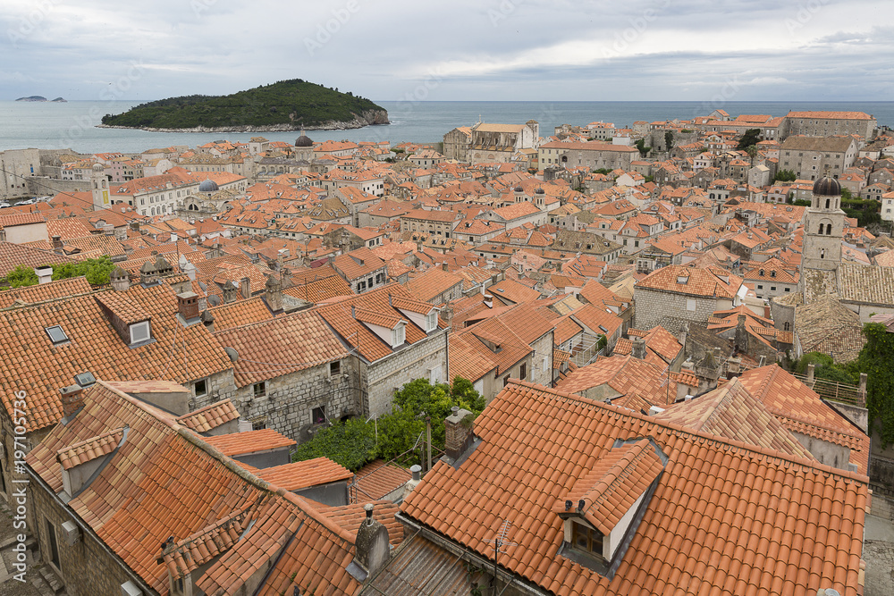 View over the orange rooftops of old town Dubrovnik from the ancient city wall with cloudy weather, Croatia