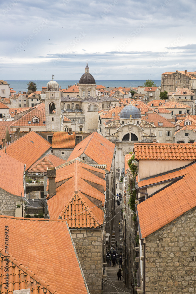 View over the orange rooftops of old town Dubrovnik from the ancient city wall with cloudy weather, Croatia